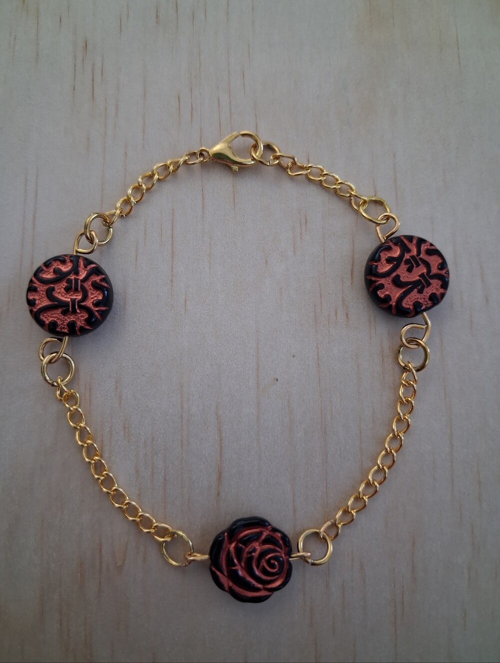 Stainless Steel Gold Chain Bracelet with Black and Copper Floral Accents